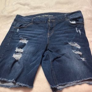 Ripped double buttoned jean shorts.